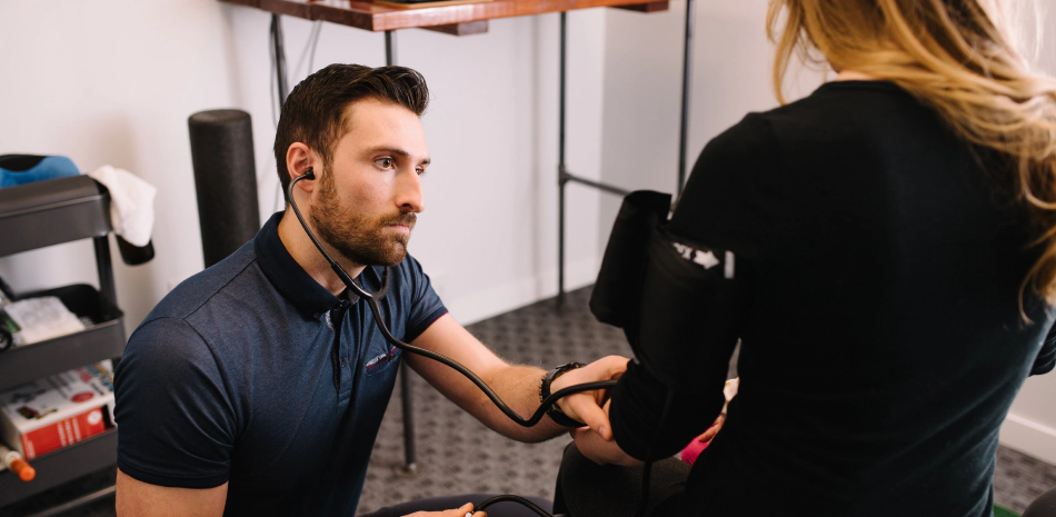 doctor checking the pressure status of a woman doctor checking the pressure status of a woman